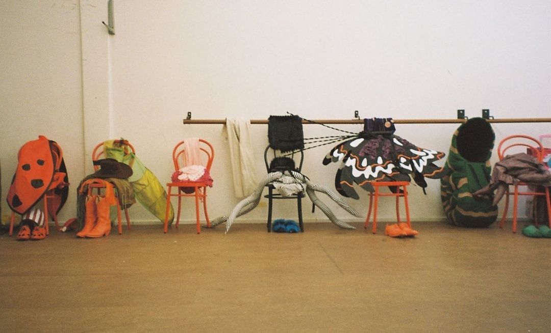 The band's costumes from Catching Smoke sitting on chairs.